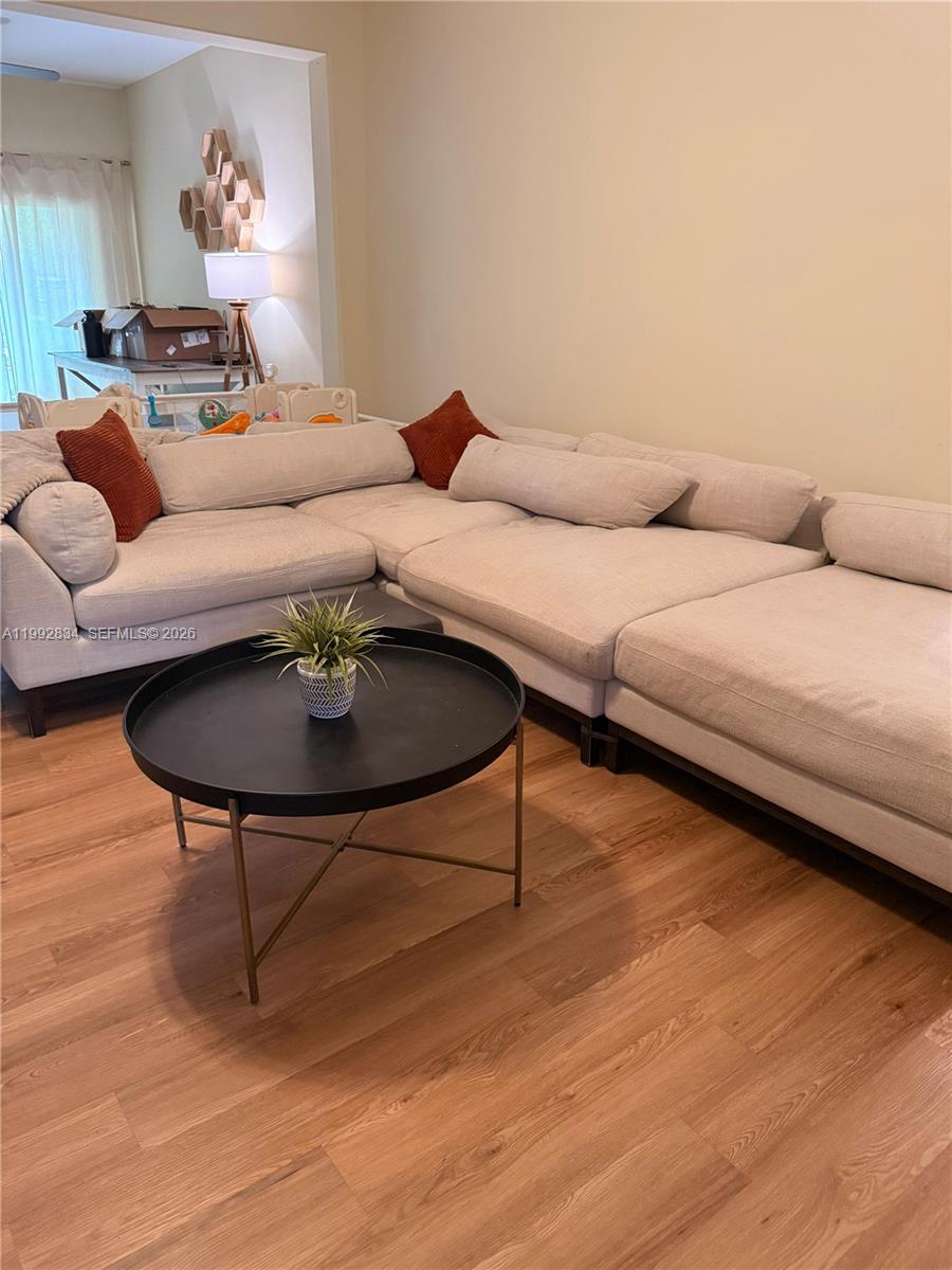 3154 Rodrick Circle Orlando, FL 32824 - Photo 6 of 21 a living room with furniture and a wooden floor