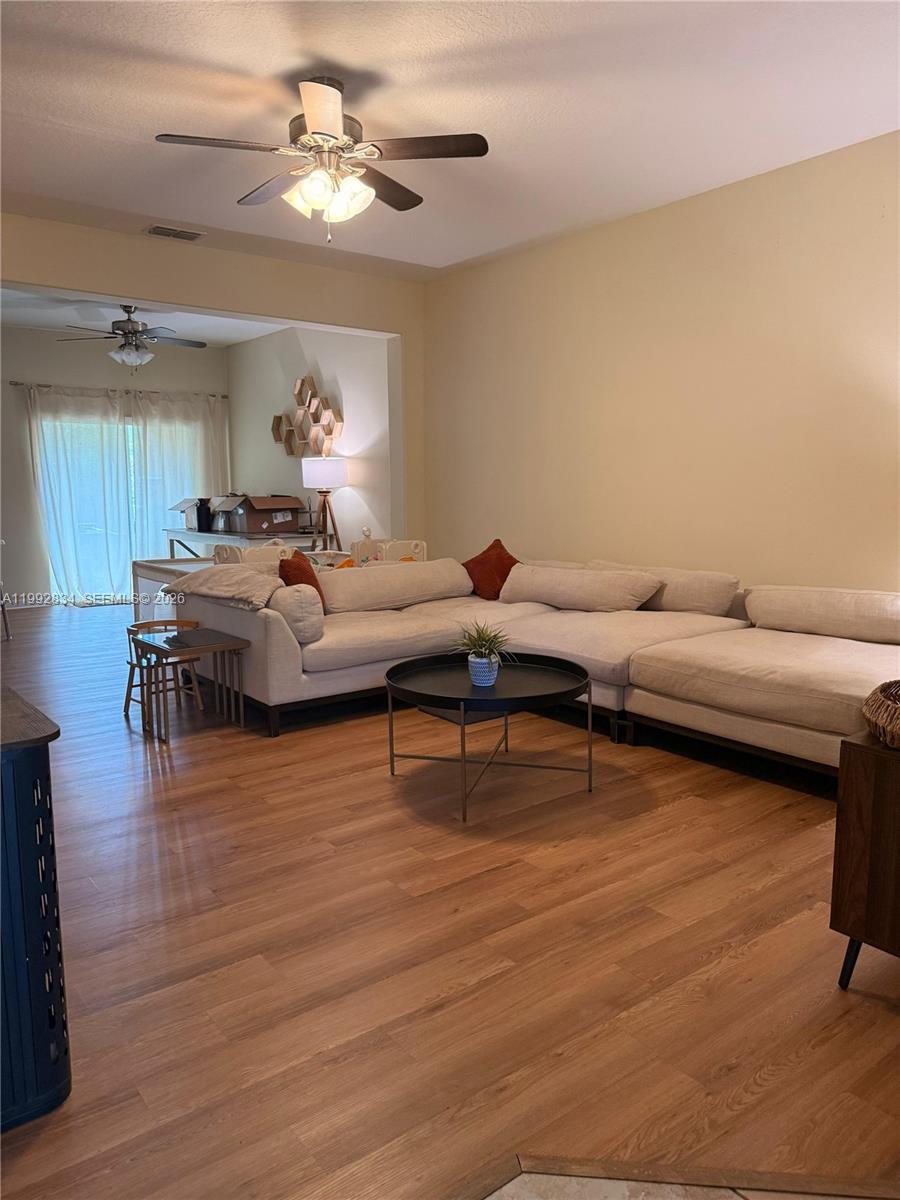 3154 Rodrick Circle Orlando, FL 32824 - Photo 7 of 21 a living room with furniture and a wooden floor