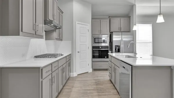a kitchen with stainless steel appliances a refrigerator sink and microwave