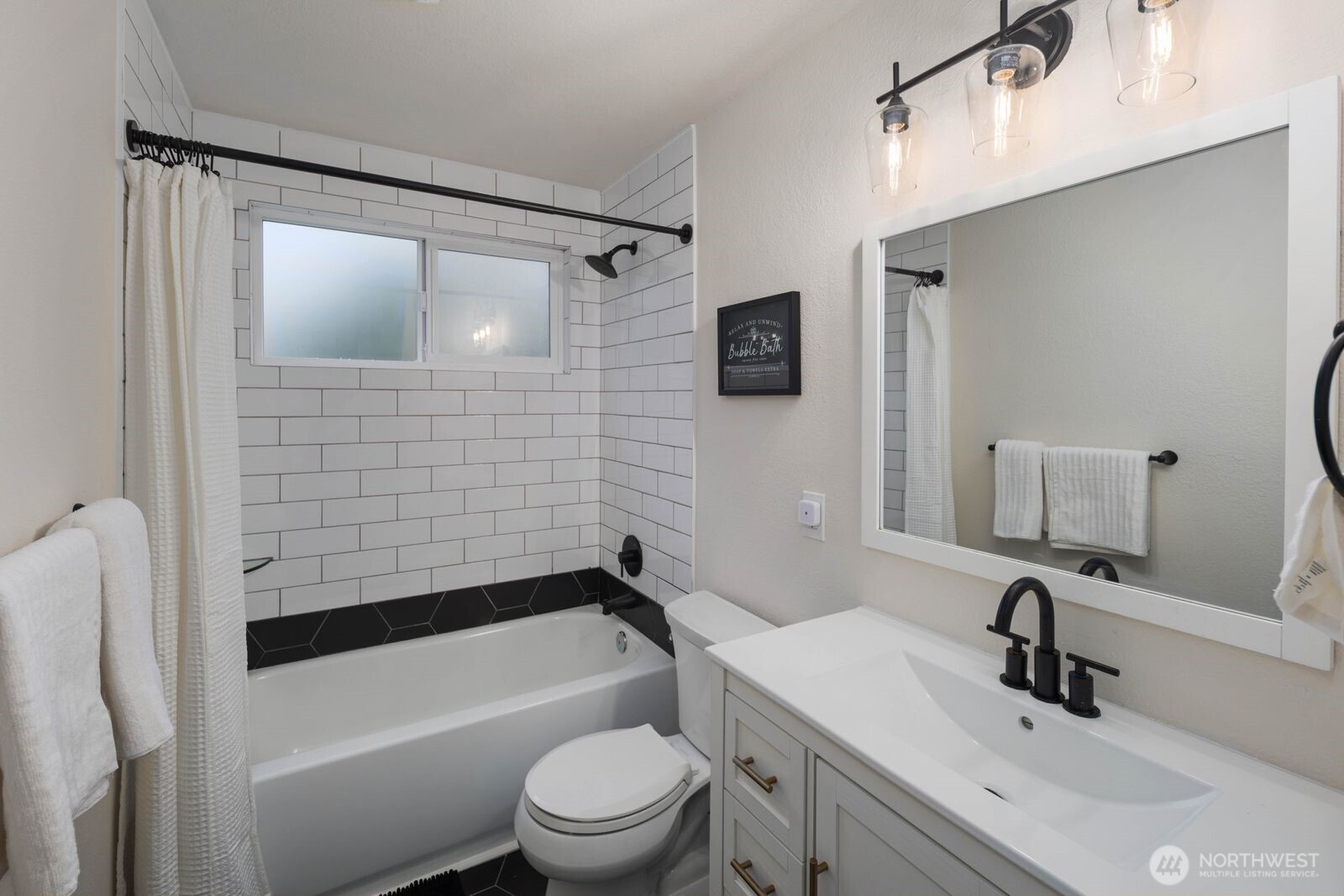 612 19th Street Snohomish, WA 98290 - Photo 18 of 33 a bathroom with a bathtub shower sink vanity mirror and toilet