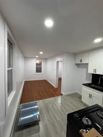 a view of a hallway with entryway and stairs