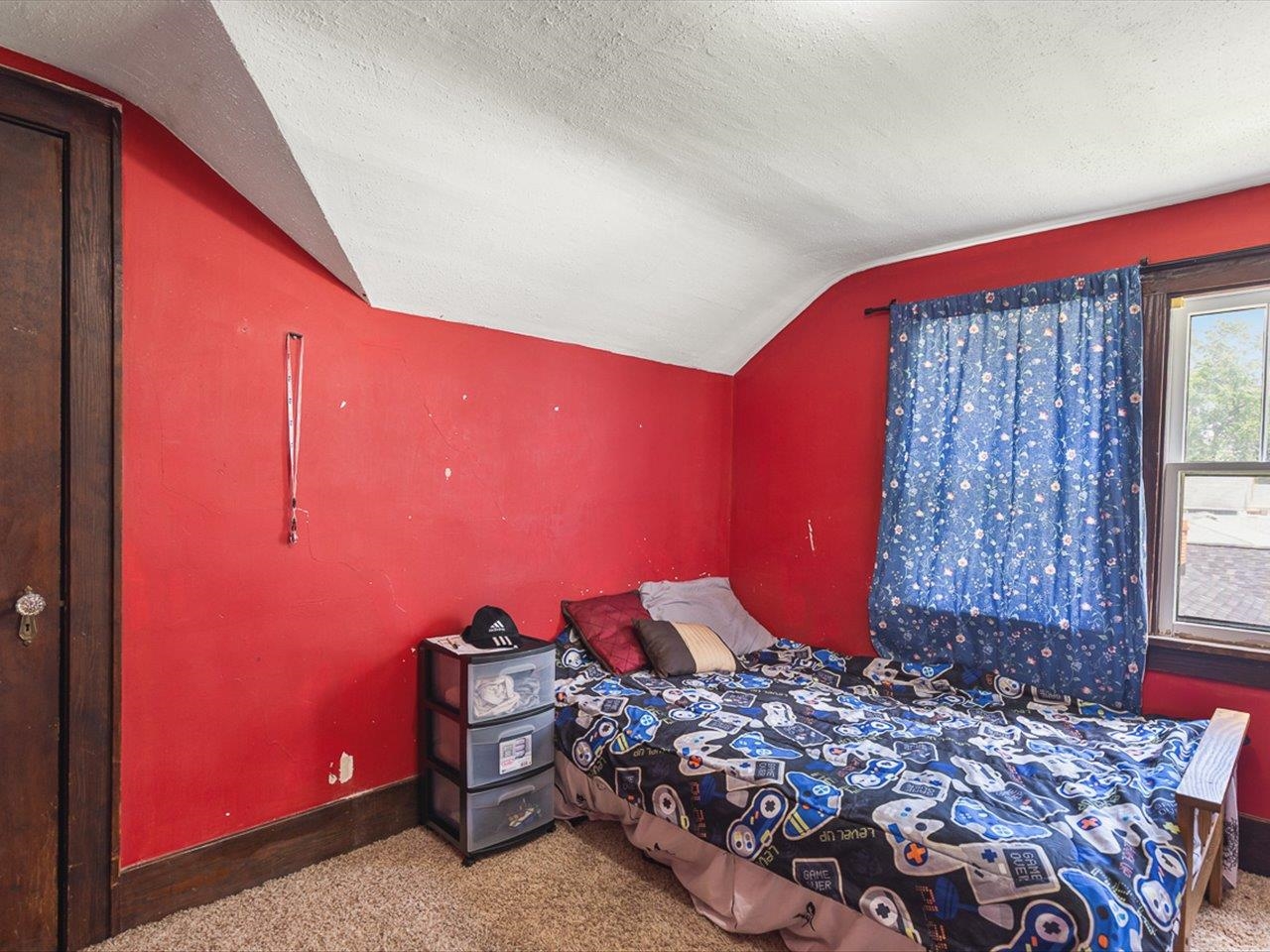 1247 West Logan Street Freeport, IL 61032 - Photo 20 of 34 a bed sitting in a bedroom next to a window