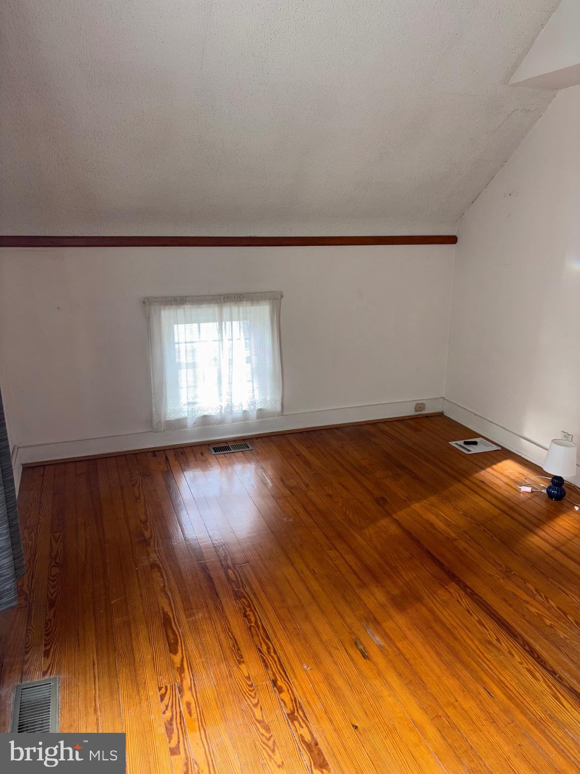 25 Baker Street Aberdeen, MD 21001 - Photo 18 of 23 a view of empty room with wooden floor and fan