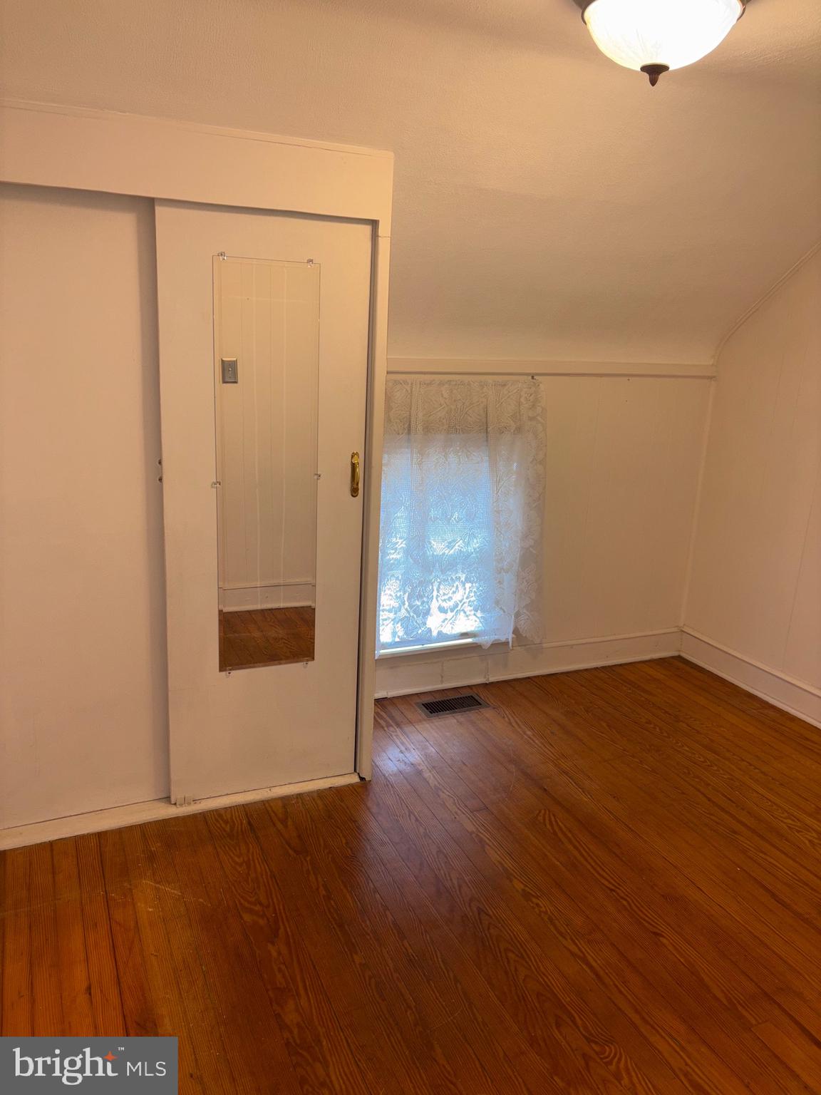 25 Baker Street Aberdeen, MD 21001 - Photo 21 of 23 a view of an empty room with wooden floor and a window