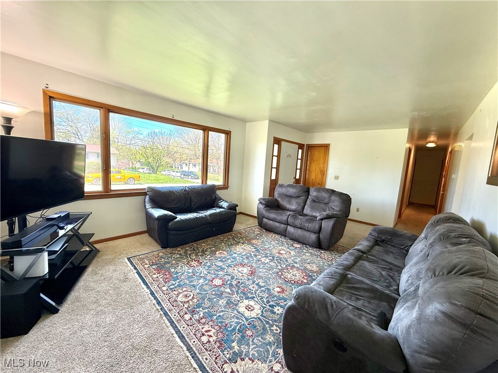 4669 Mars Road Uniontown, OH 44685 - Photo 9 of 31 Living area featuring carpet and baseboards