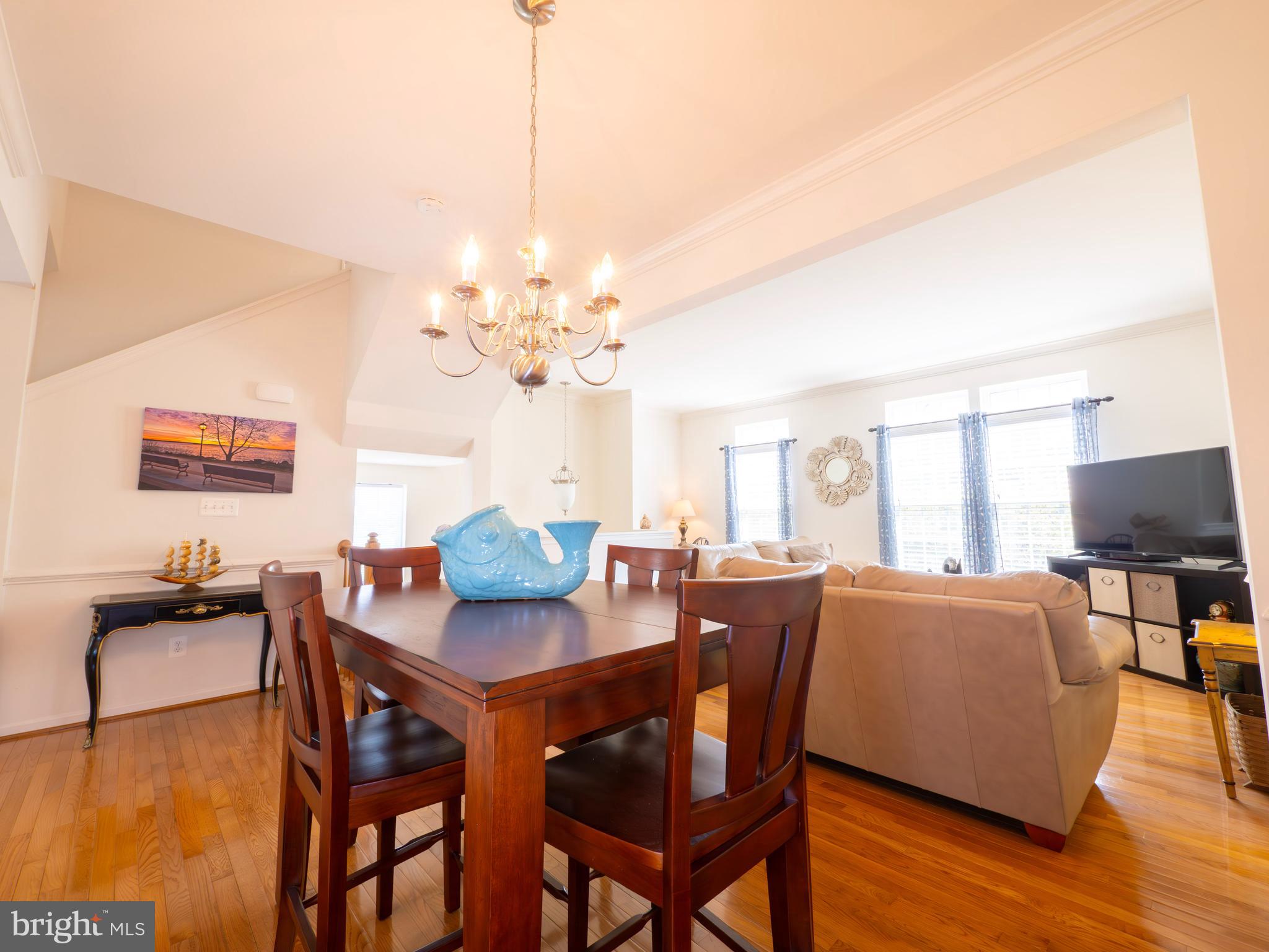 301 Monroe Point Drive Colonial Beach, VA 22443 - Photo 11 of 33 a view of a dining room with furniture a chandelier and wooden floor