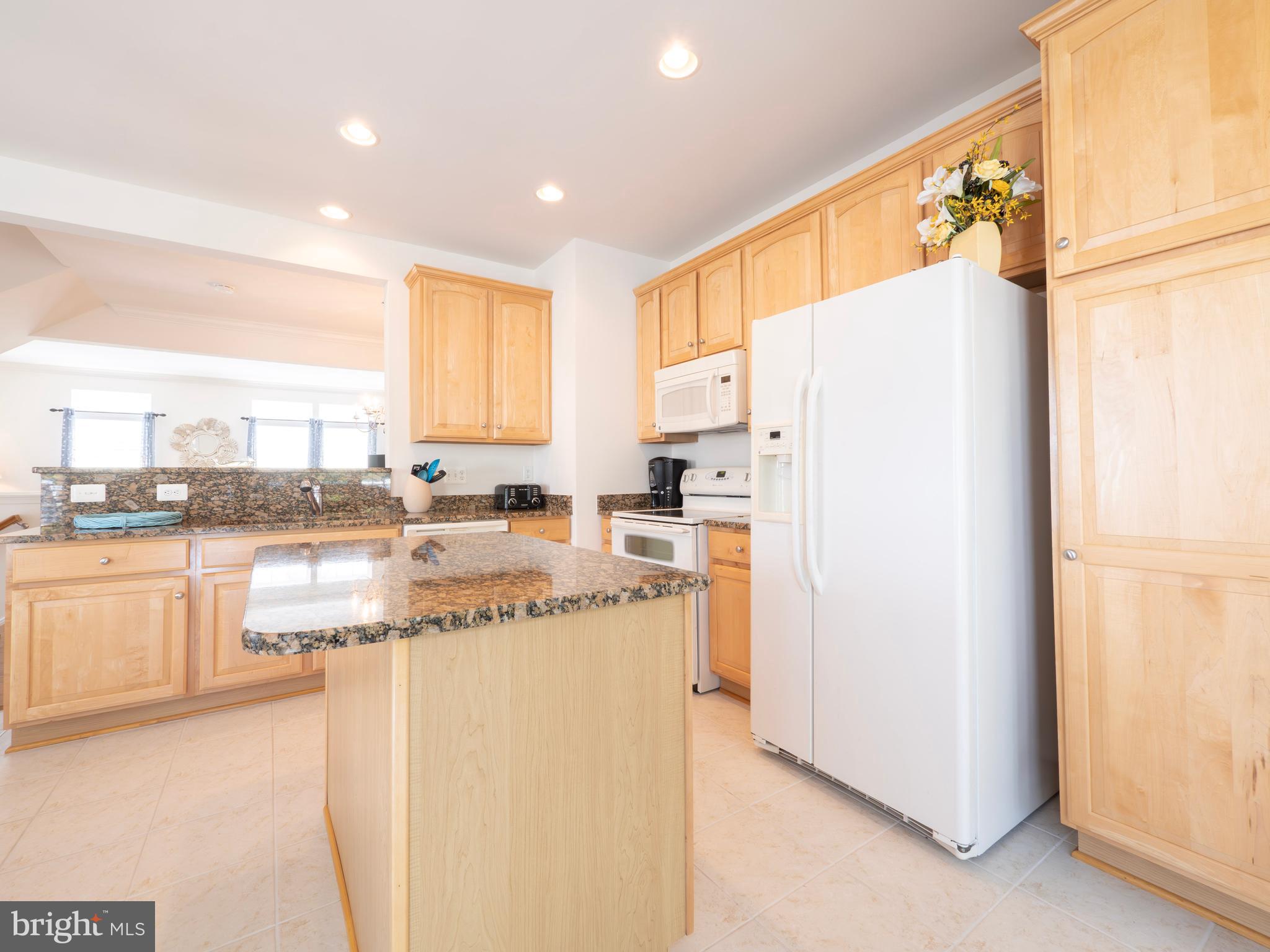 301 Monroe Point Drive Colonial Beach, VA 22443 - Photo 13 of 33 a kitchen with stainless steel appliances granite countertop a refrigerator a stove and a sink with wooden floor