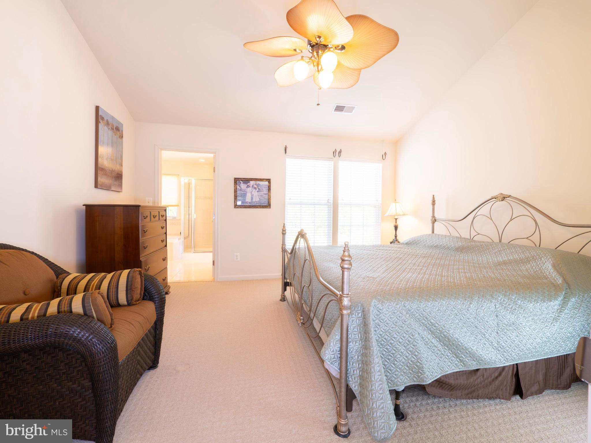 301 Monroe Point Drive Colonial Beach, VA 22443 - Photo 17 of 33 a bedroom with a bed and a chandelier