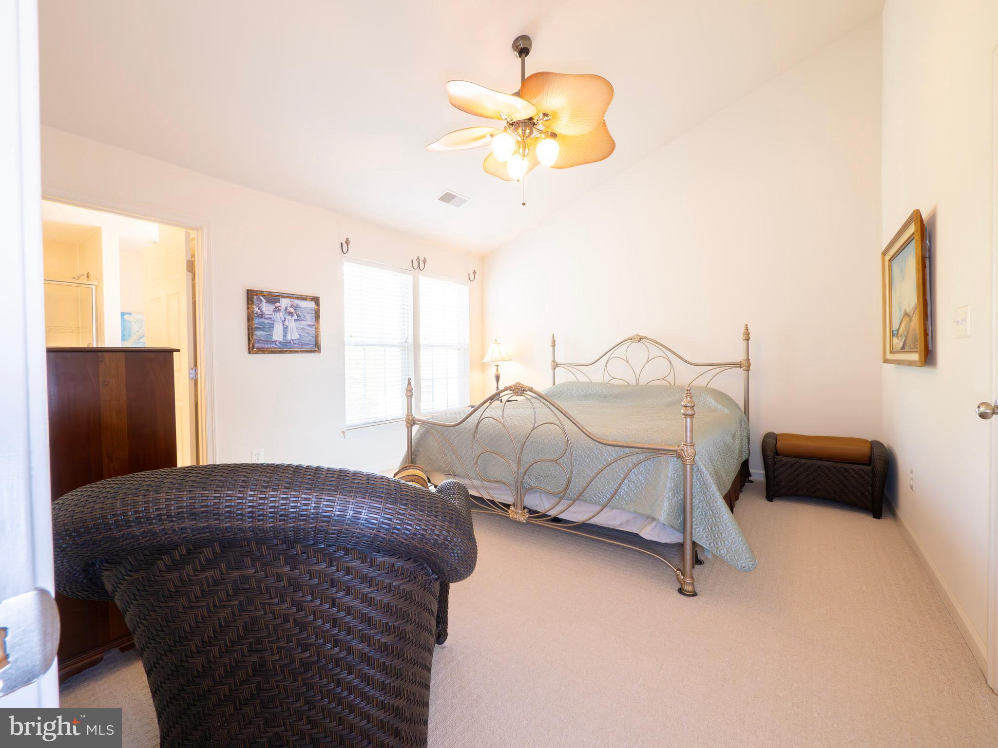 301 Monroe Point Drive Colonial Beach, VA 22443 - Photo 18 of 33 a bedroom with a bed and a chandelier