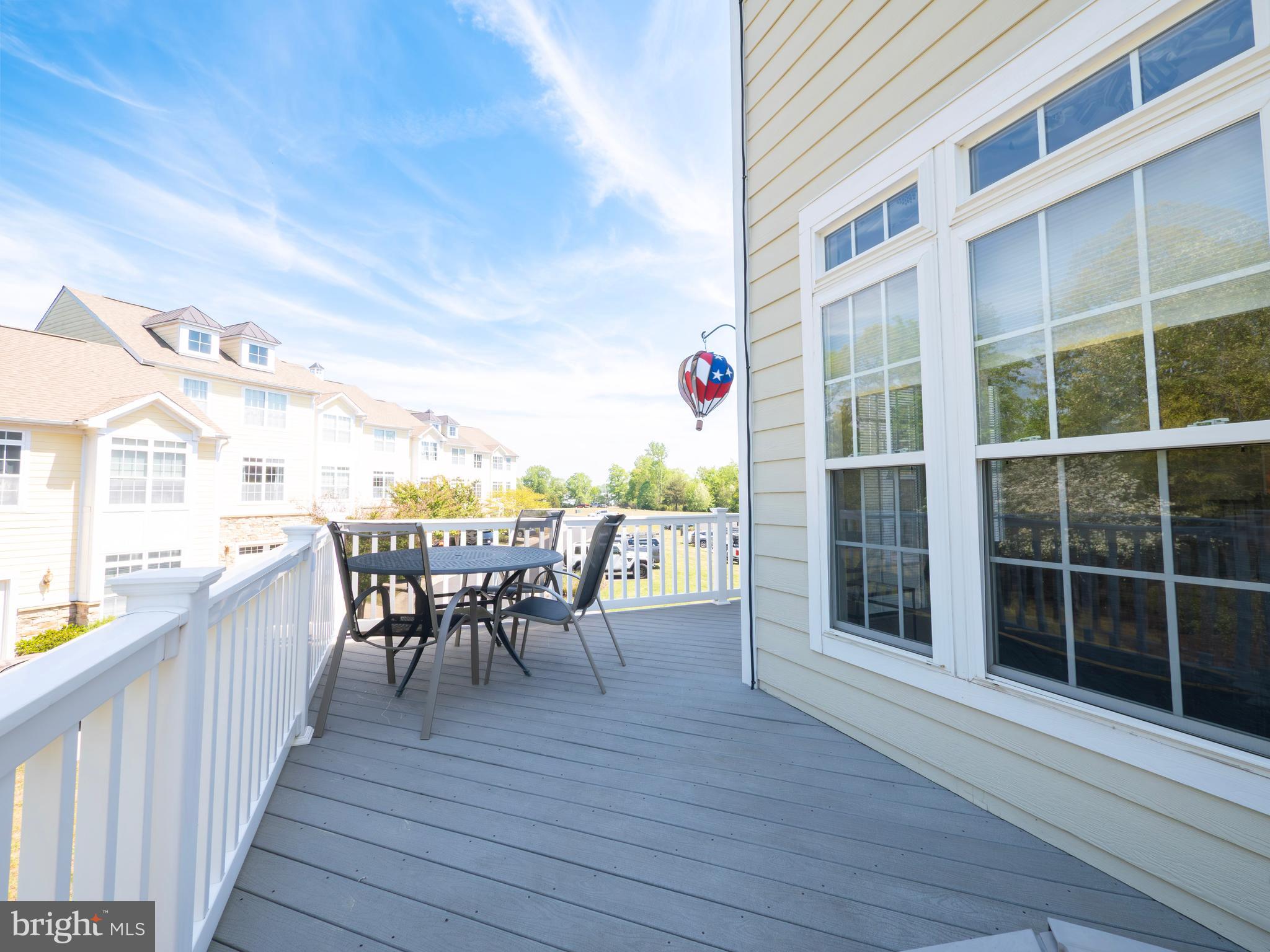 301 Monroe Point Drive Colonial Beach, VA 22443 - Photo 29 of 33 a view of a roof deck with table and chairs and wooden floor