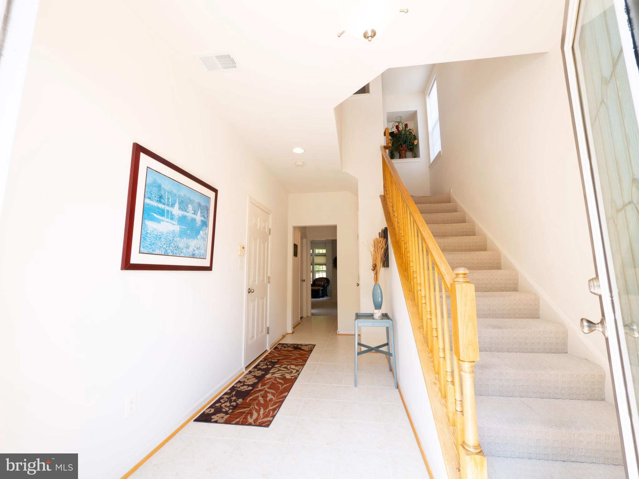 301 Monroe Point Drive Colonial Beach, VA 22443 - Photo 3 of 33 a view of a hallway with wooden floor and staircase