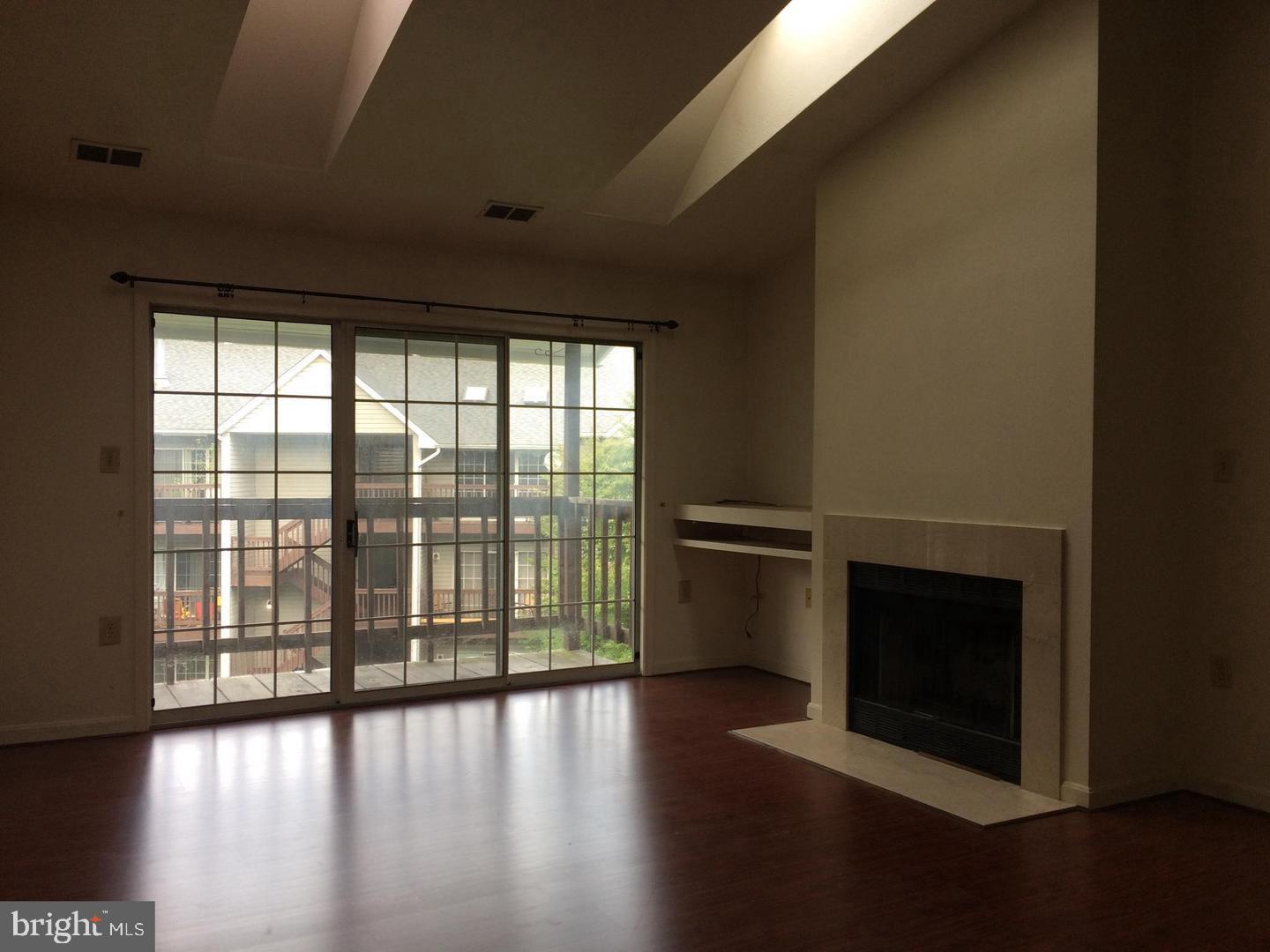 104 Timberlake Terrace, Unit 12 Stephens City, VA 22655 - Photo 2 of 8 a view of wooden floor and windows in a room