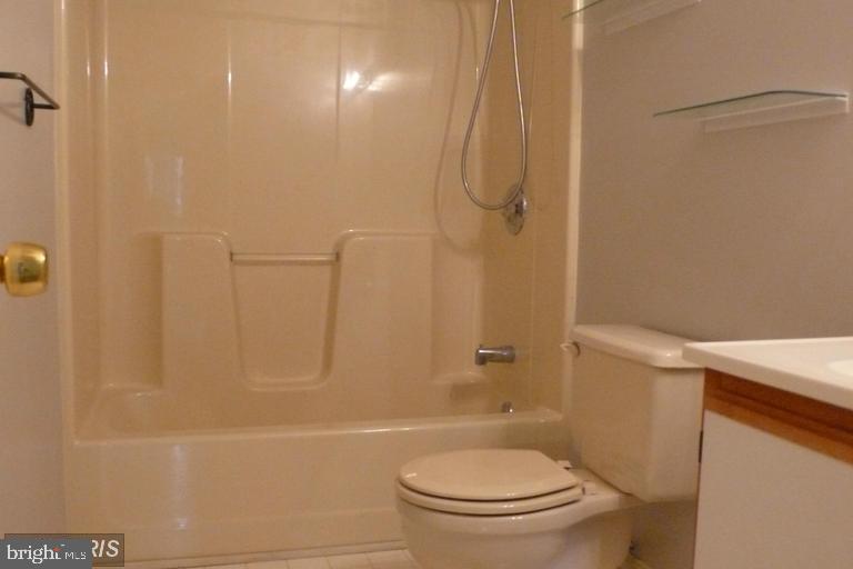 104 Timberlake Terrace, Unit 12 Stephens City, VA 22655 - Photo 6 of 8 a white toilet sitting next to a bath tub