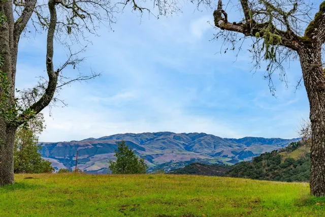 a view of an mountain with backyard of house