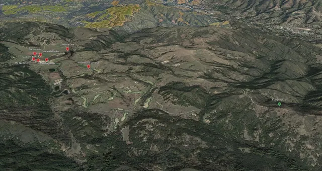 a backyard of a house with lots of green space and forest