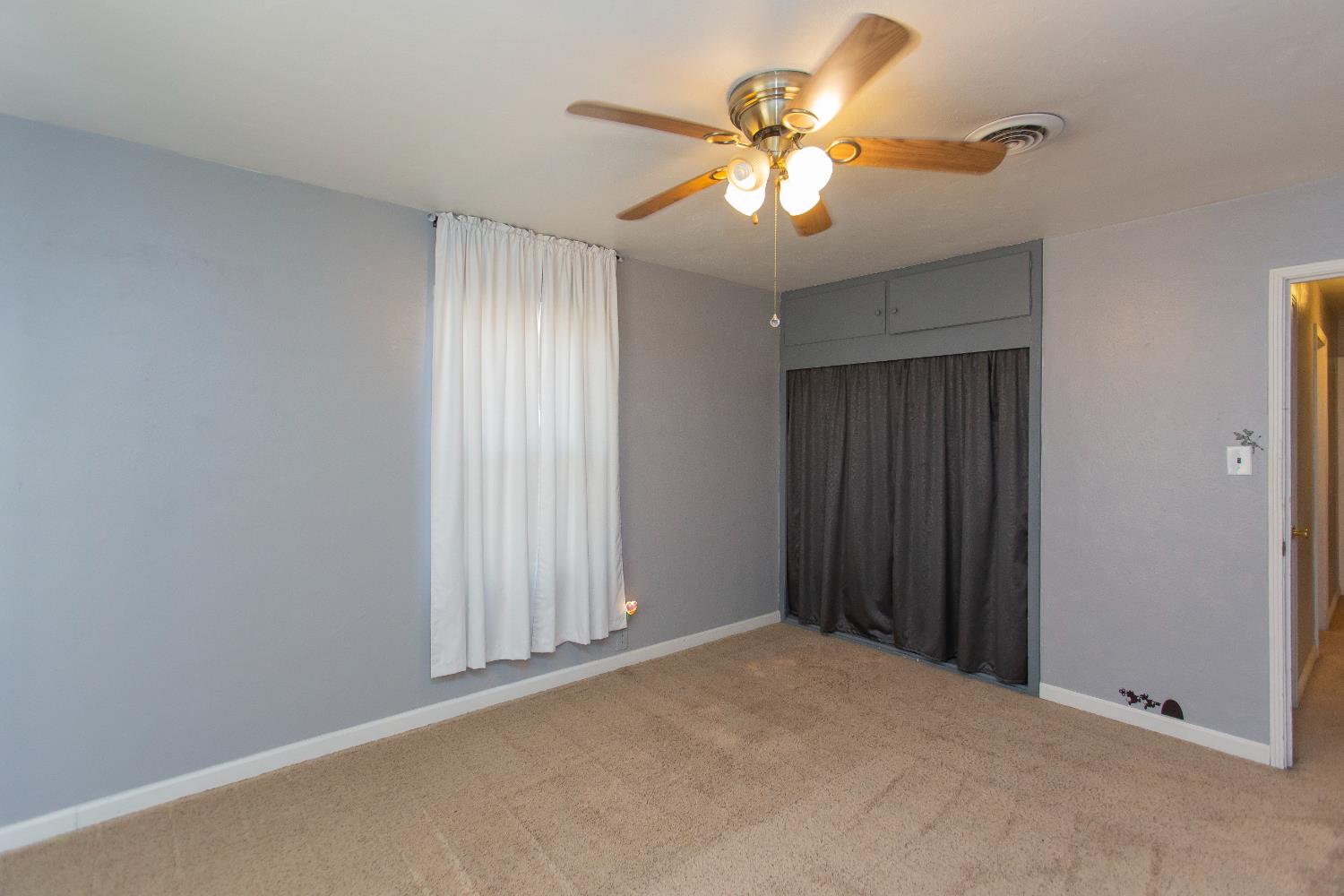 401 Fortuna Avenue Modesto, CA 95354 - Photo 19 of 43 a view of an empty room with a chandelier fan