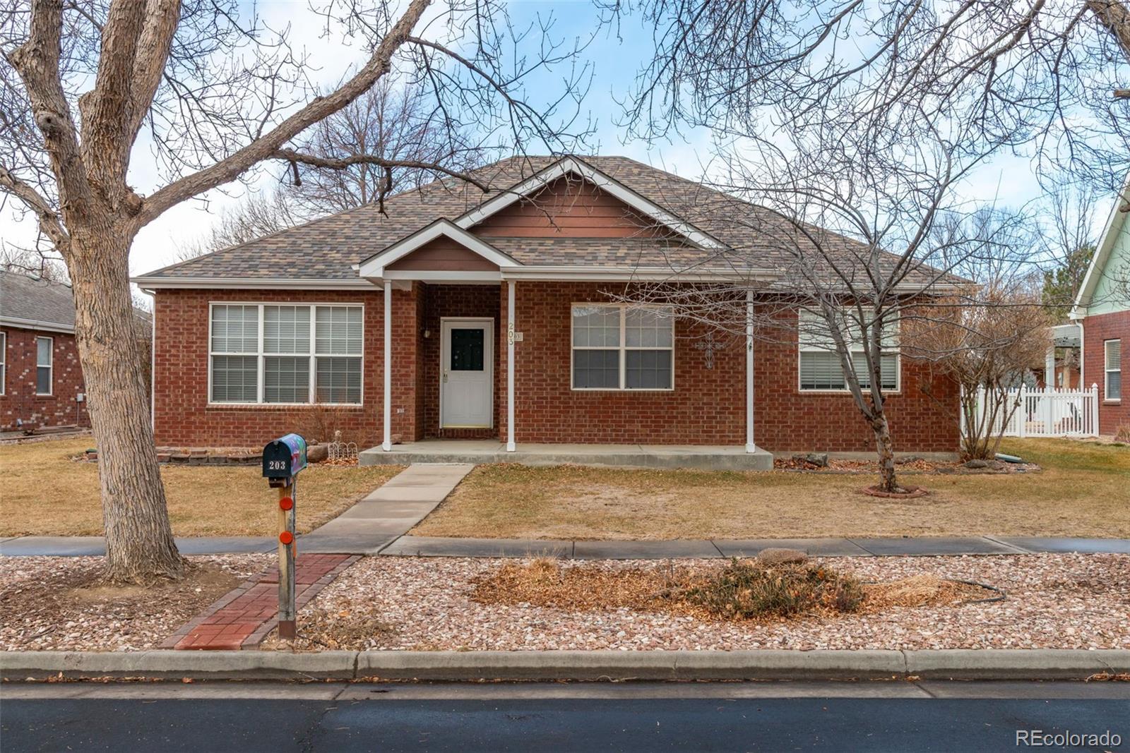 203 Hubbell Street Berthoud, CO 80513 - Photo 1 of 49 a front view of a house with garden