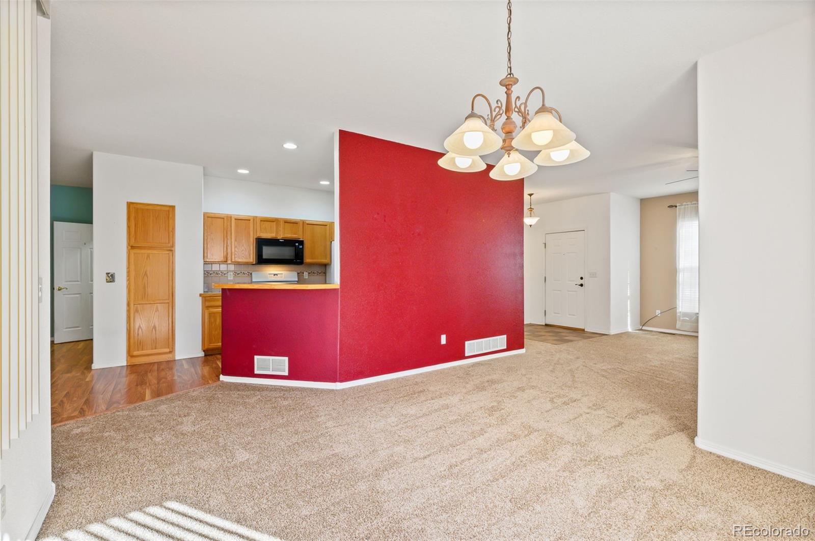 203 Hubbell Street Berthoud, CO 80513 - Photo 14 of 49 a view of an empty room with a kitchen