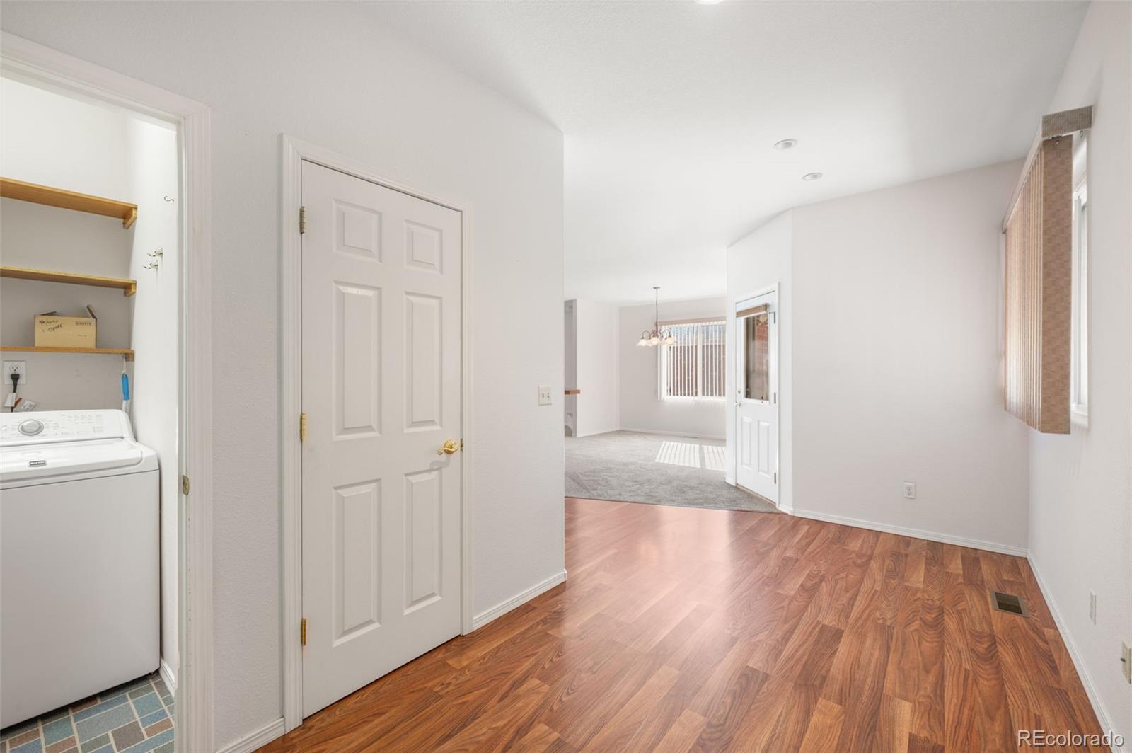 203 Hubbell Street Berthoud, CO 80513 - Photo 15 of 49 a view of a livingroom with wooden floor and cabinet