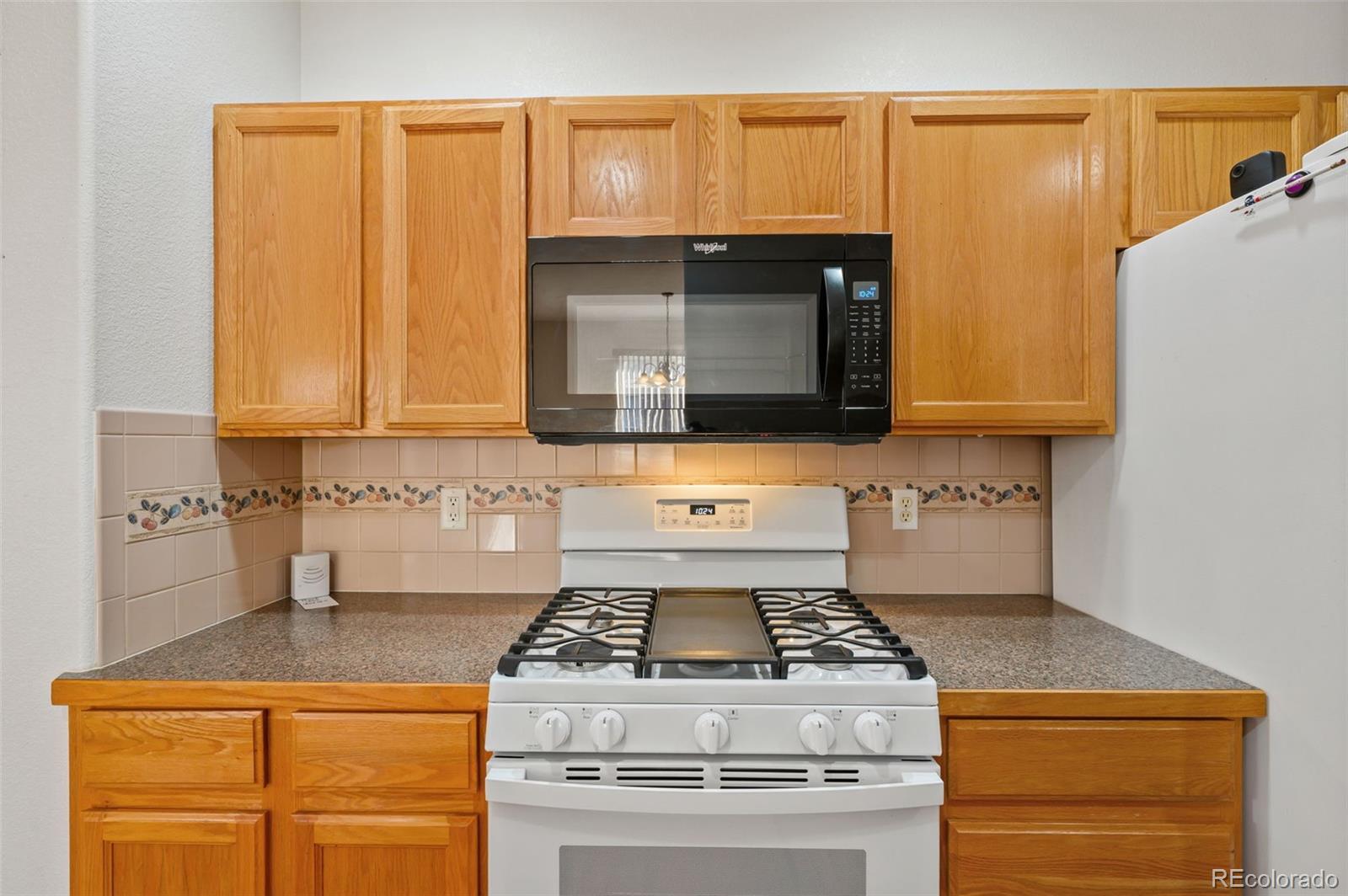 203 Hubbell Street Berthoud, CO 80513 - Photo 20 of 49 a stove top oven sitting inside of a kitchen