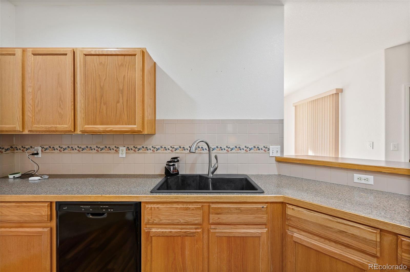 203 Hubbell Street Berthoud, CO 80513 - Photo 21 of 49 a kitchen with stainless steel appliances granite countertop white cabinets and a sink