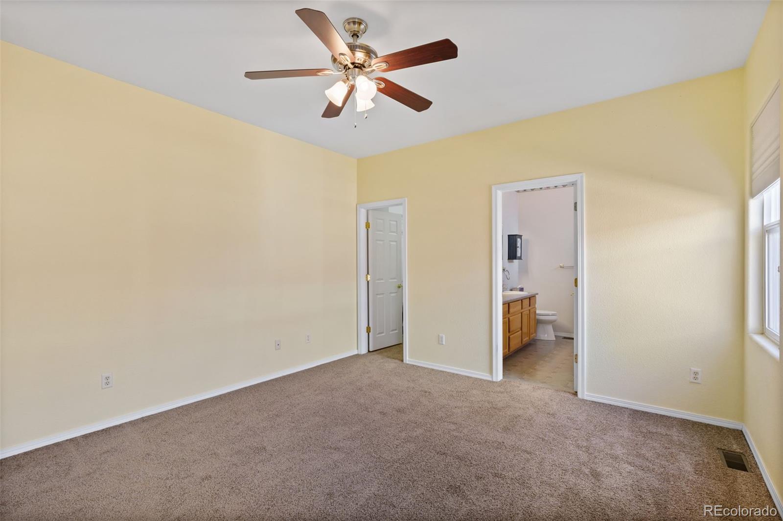 203 Hubbell Street Berthoud, CO 80513 - Photo 24 of 49 an empty room with a ceiling fan and a window