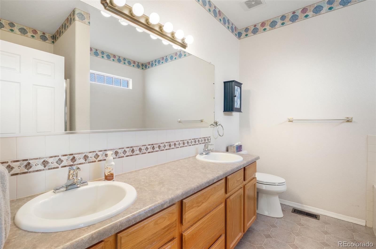 203 Hubbell Street Berthoud, CO 80513 - Photo 25 of 49 a bathroom with a sink and a mirror