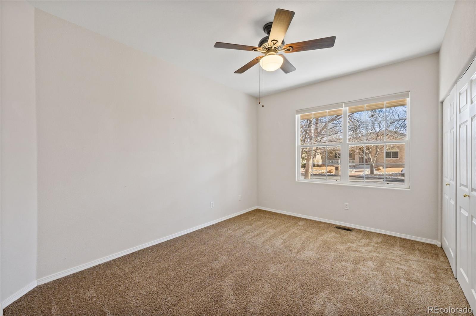 203 Hubbell Street Berthoud, CO 80513 - Photo 28 of 49 an empty room with window and ceiling fan