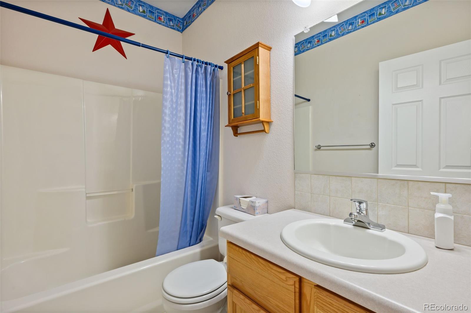 203 Hubbell Street Berthoud, CO 80513 - Photo 29 of 49 a bathroom with a sink a toilet and shower
