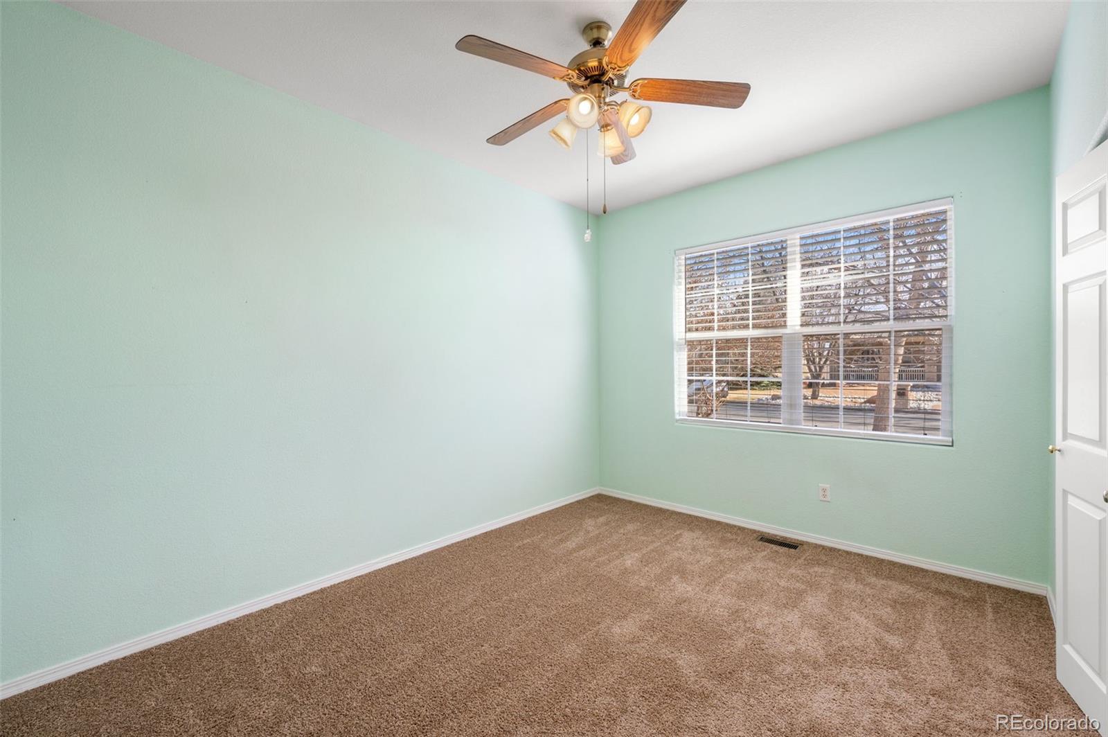 203 Hubbell Street Berthoud, CO 80513 - Photo 30 of 49 an empty room with a window and a fan