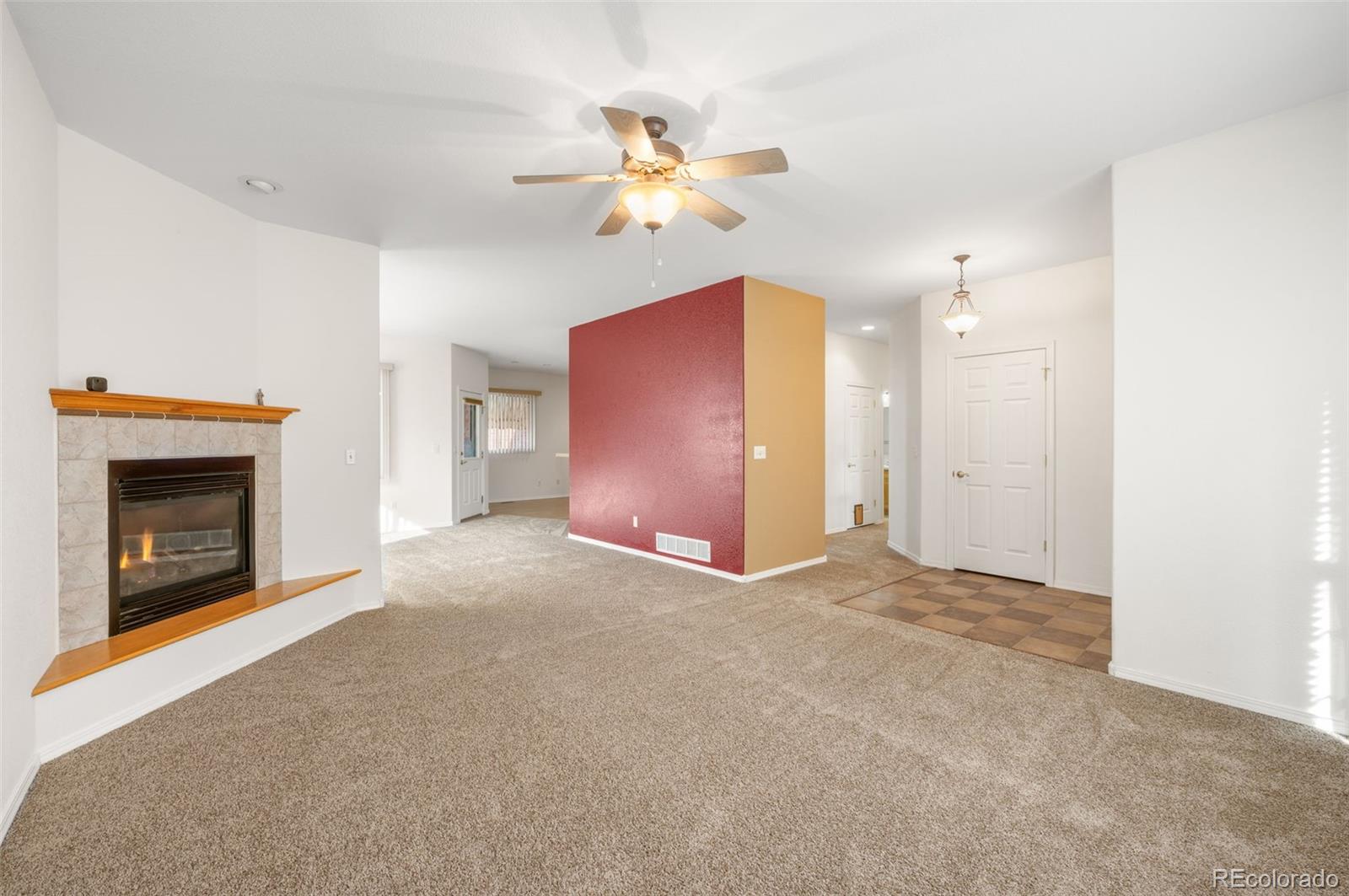 203 Hubbell Street Berthoud, CO 80513 - Photo 10 of 49 a view of an empty room with chandelier fan and fire place
