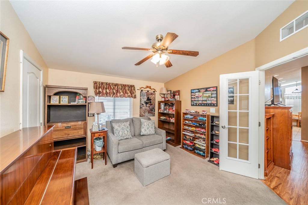22241 Nisqually Road, Unit 118 Apple Valley, CA 92308 - Photo 13 of 56 a bedroom with furniture and a chandelier