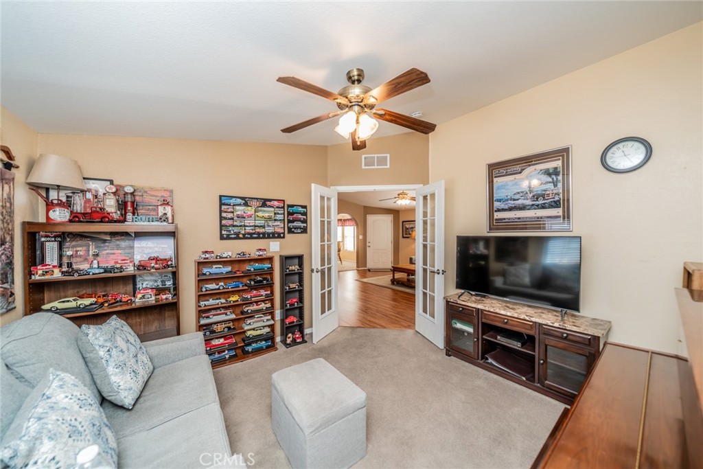 22241 Nisqually Road, Unit 118 Apple Valley, CA 92308 - Photo 14 of 56 a living room with furniture and a flat screen tv