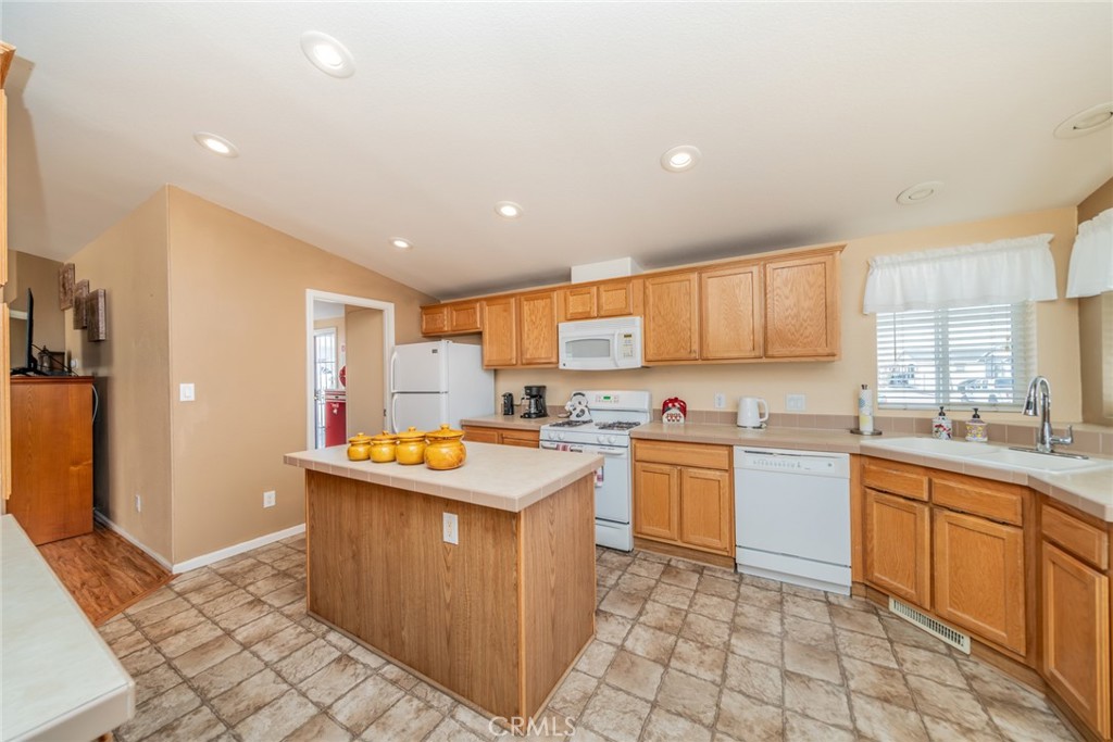 22241 Nisqually Road, Unit 118 Apple Valley, CA 92308 - Photo 16 of 56 a kitchen with a sink a counter top space and stainless steel appliances