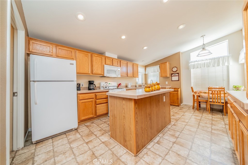22241 Nisqually Road, Unit 118 Apple Valley, CA 92308 - Photo 2 of 56 a kitchen with a refrigerator and a sink