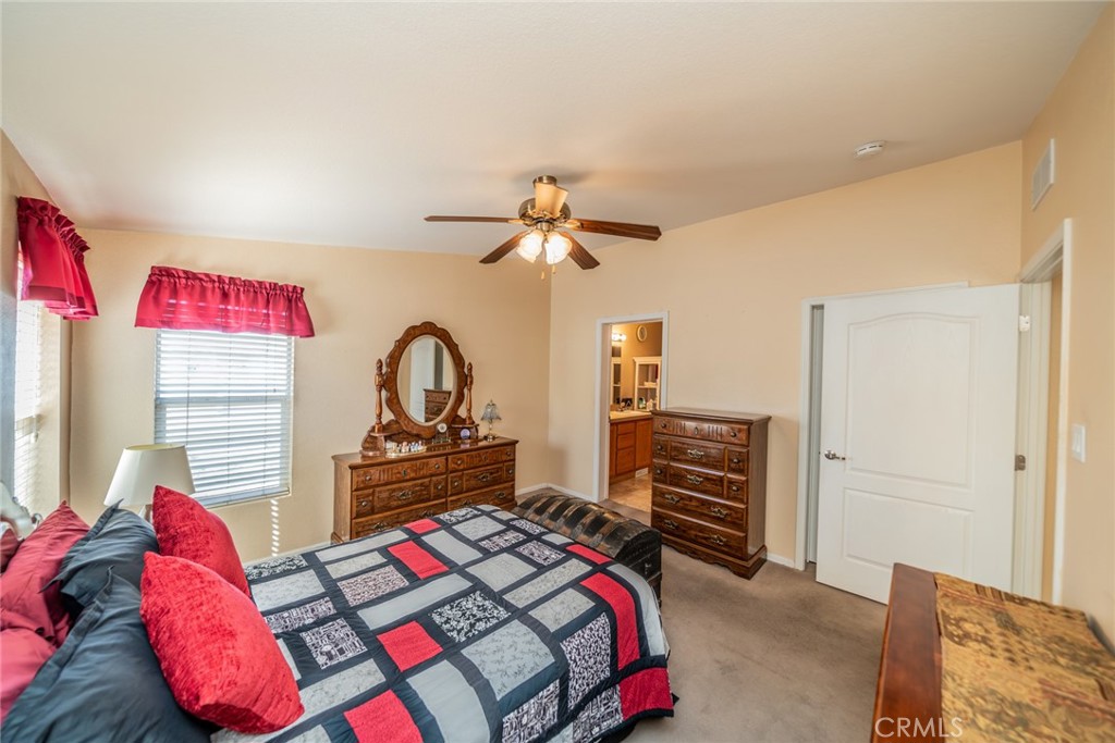 22241 Nisqually Road, Unit 118 Apple Valley, CA 92308 - Photo 23 of 56 a bedroom with a bed and a dresser