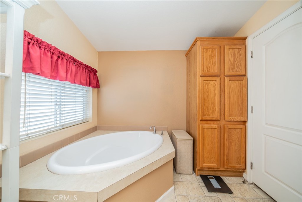 22241 Nisqually Road, Unit 118 Apple Valley, CA 92308 - Photo 25 of 56 a bathroom with a bathtub