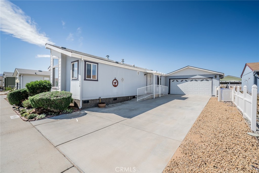 22241 Nisqually Road, Unit 118 Apple Valley, CA 92308 - Photo 29 of 56 a front view of a house with a yard
