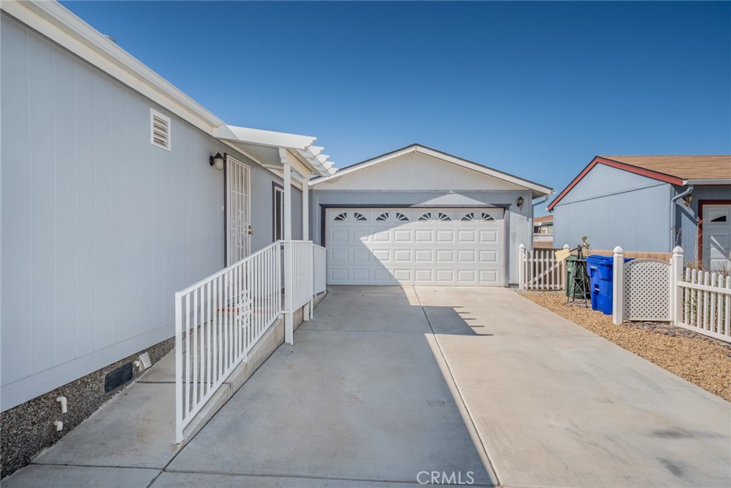 22241 Nisqually Road, Unit 118 Apple Valley, CA 92308 - Photo 30 of 56 a view of a house with a garage