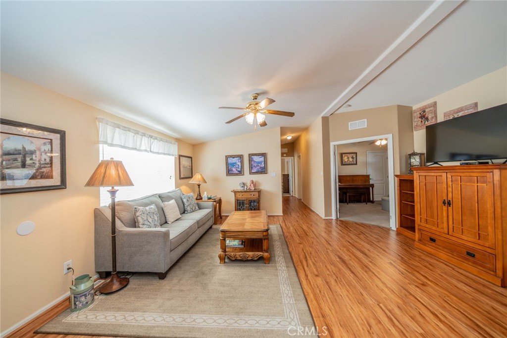 22241 Nisqually Road, Unit 118 Apple Valley, CA 92308 - Photo 6 of 56 a living room with furniture and a flat screen tv