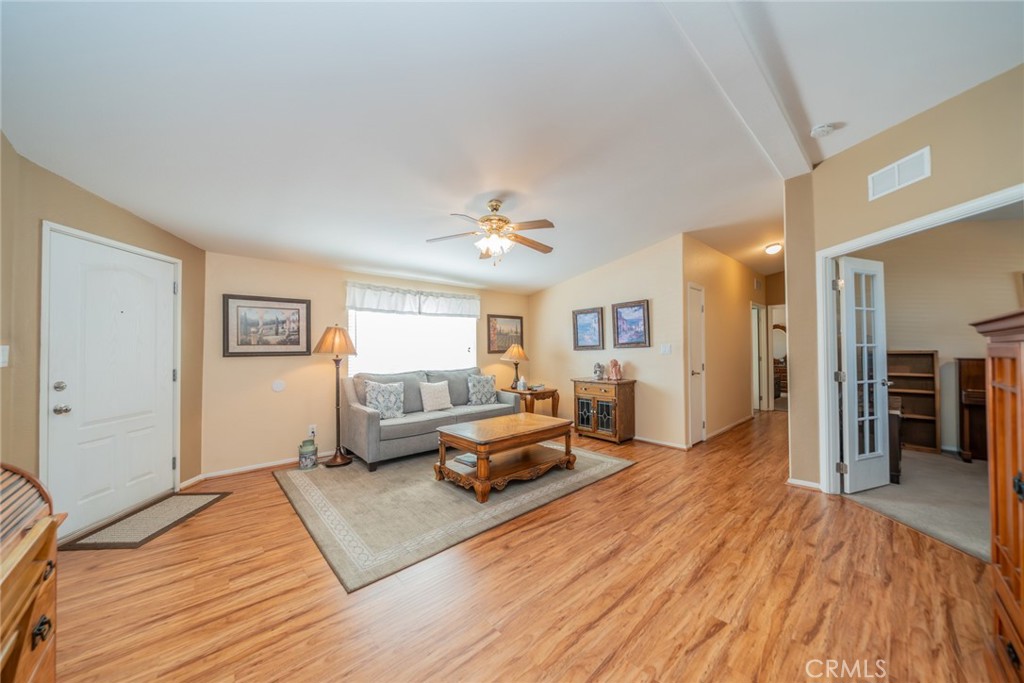 22241 Nisqually Road, Unit 118 Apple Valley, CA 92308 - Photo 7 of 56 a living room with furniture and wooden floor