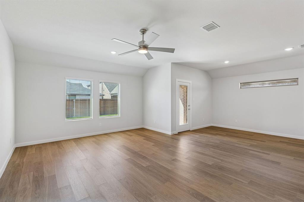 1152 Del Rio Drive Lavon, TX 75166 - Photo 12 of 33 a view of an empty room with wooden floor and a window