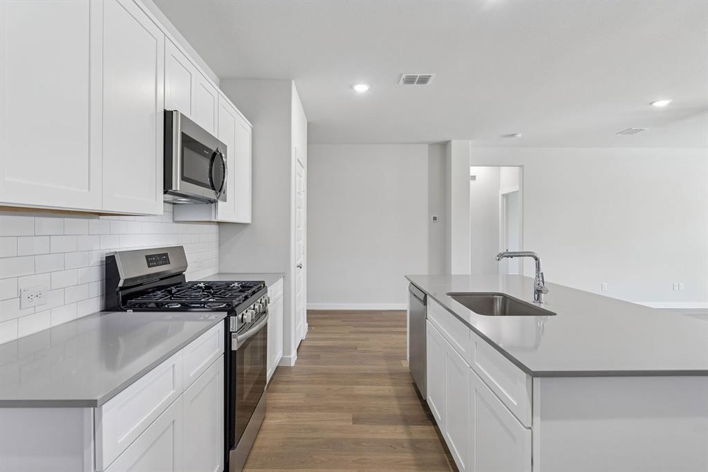 1152 Del Rio Drive Lavon, TX 75166 - Photo 7 of 33 a kitchen that has a sink and a stove