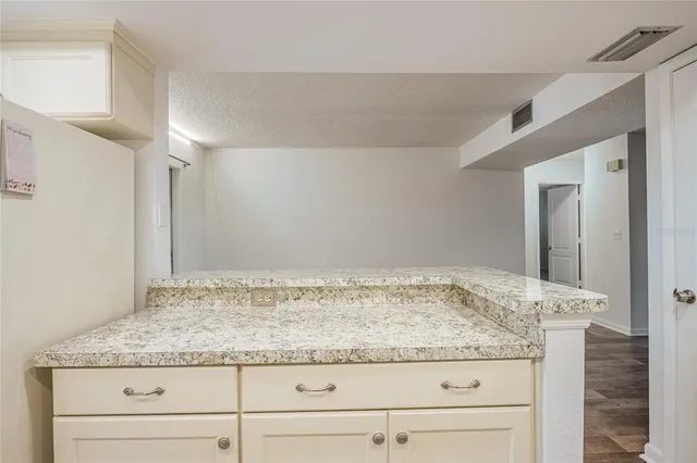 a bathroom with a granite countertop sink and vanity