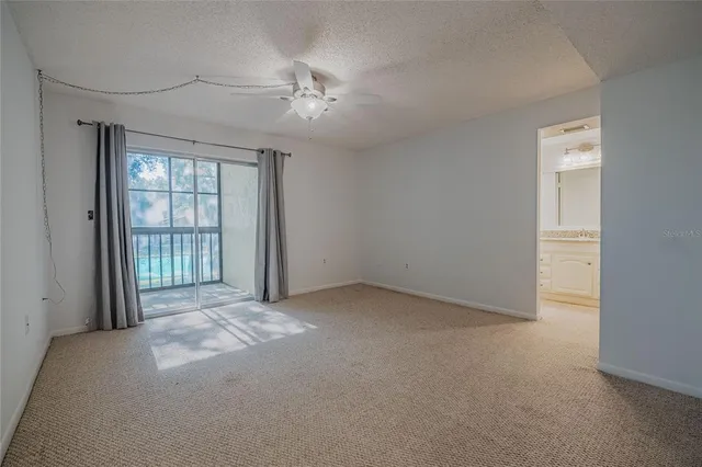 en empty room with windows and chandelier