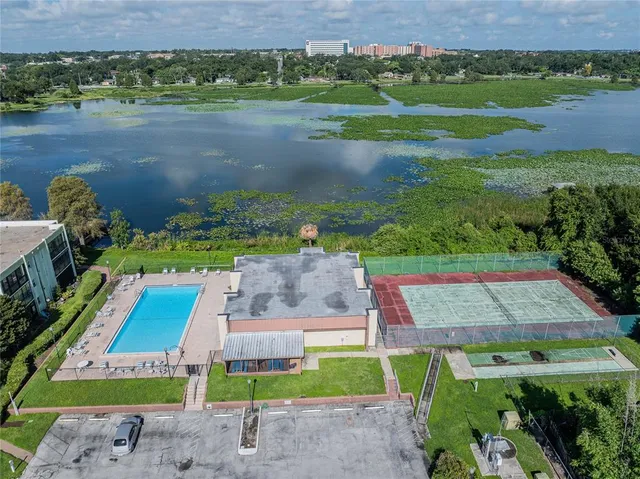 an aerial view of a house with a yard basket ball court and outdoor seating