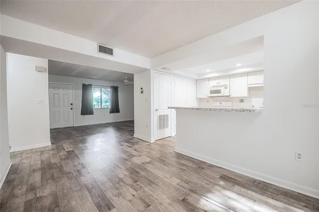 a view of a kitchen cabinets and wooden floor