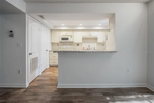 a kitchen with stainless steel appliances granite countertop a sink and cabinets