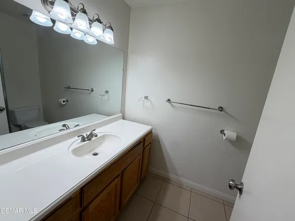 a bathroom with a sink a mirror and vanity