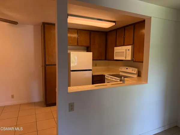 a view of a refrigerator in a kitchen
